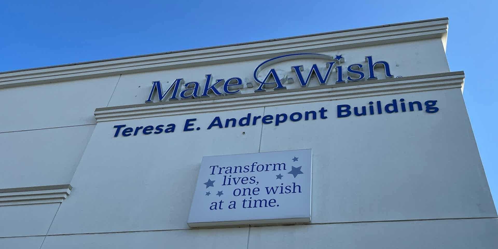Photo of signage on Make-A-Wish building including logo, “Teresa E. Andrepont Building,” and “Transform lives, one wish at a time.”